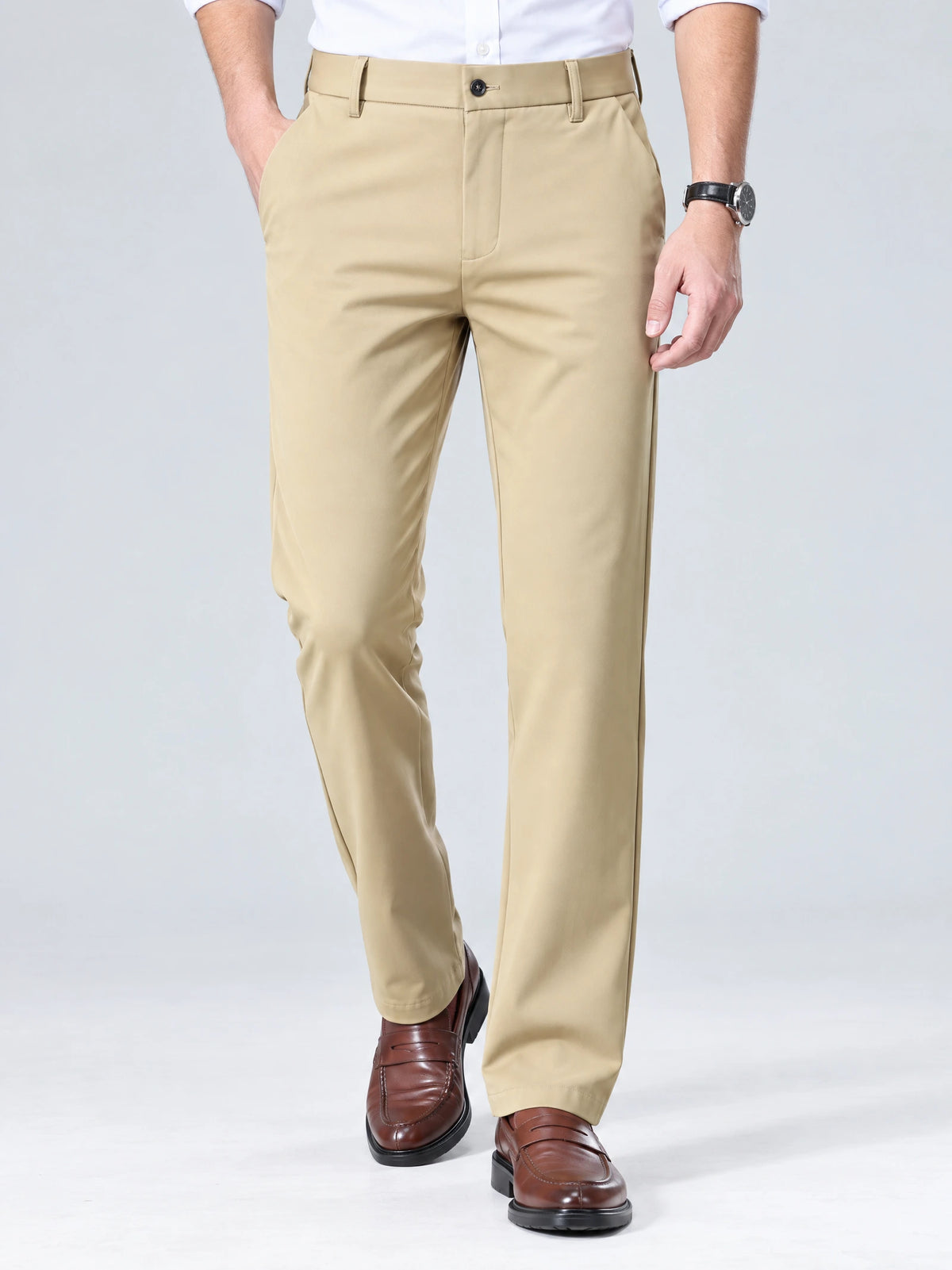 Model wearing Khaki men's straight-leg pants in a front studio view, with one hand in a side pocket.