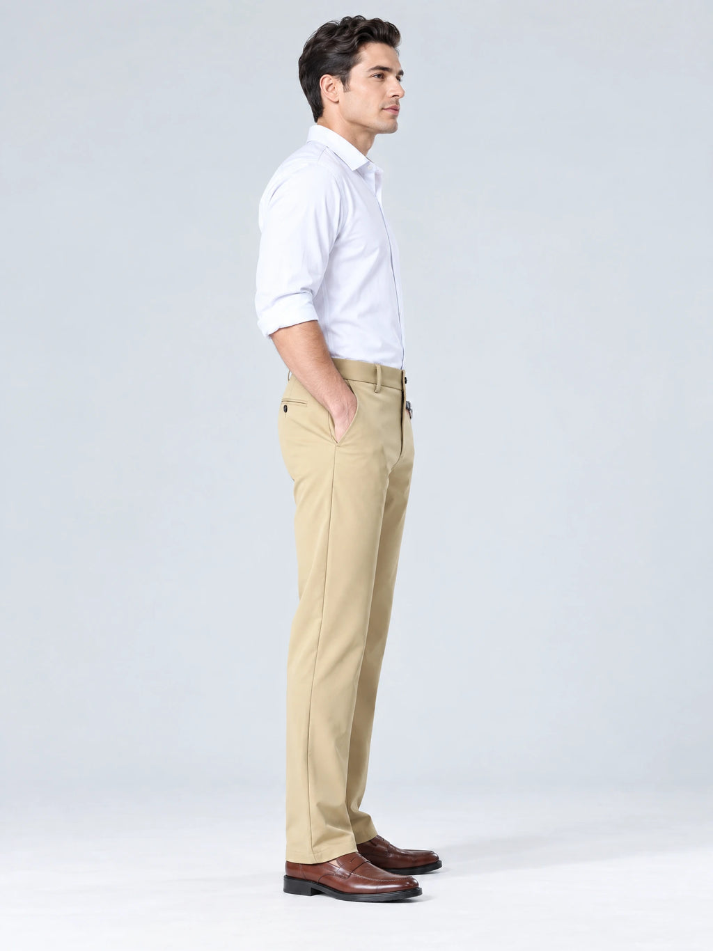 Side studio view of a model wearing Khaki men's straight pants with one hand in the side pocket.
