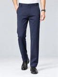 Front studio view of a model wearing Navy straight-leg men's pants with a button waistband and side pockets.