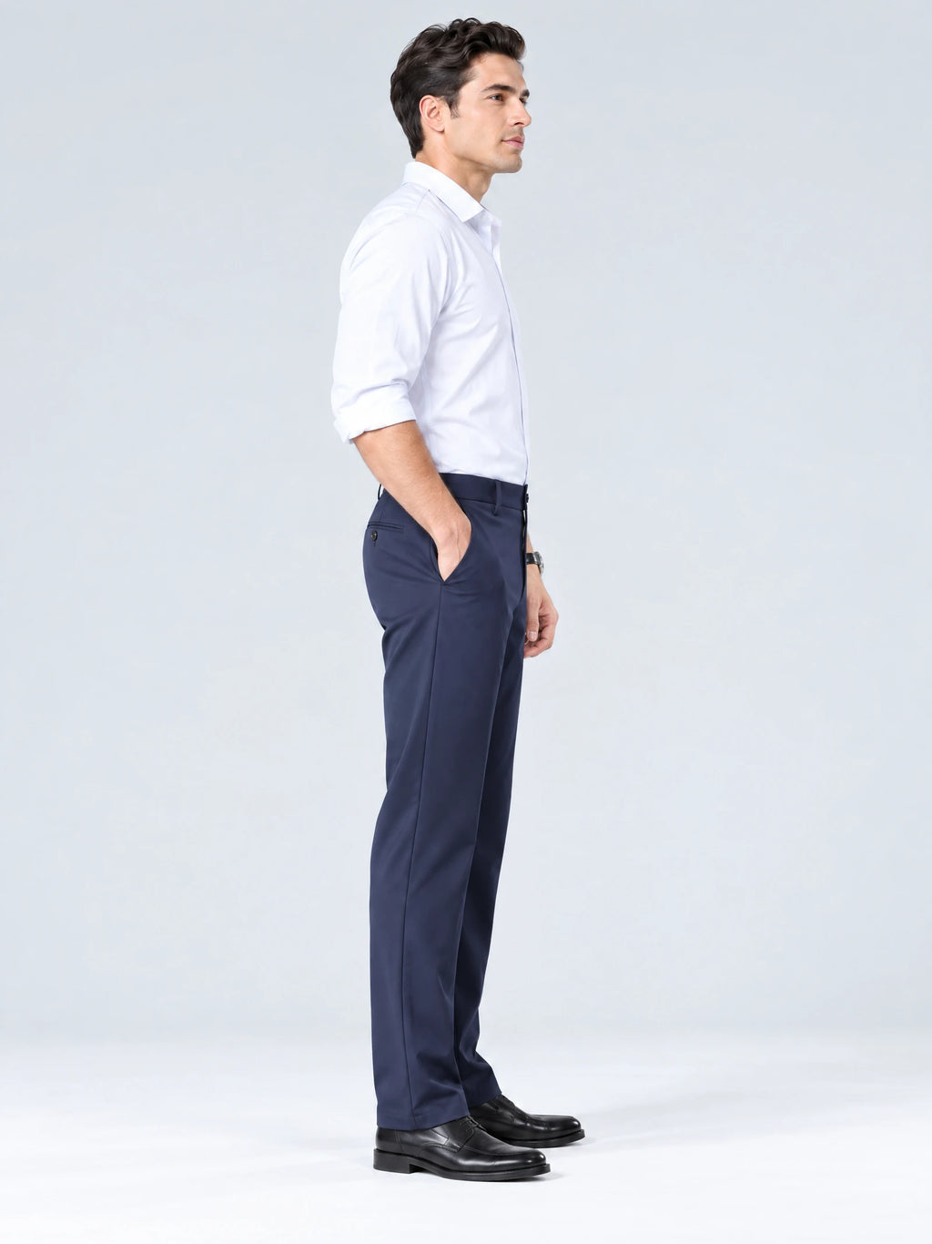 Side studio view of a model wearing Navy men's straight pants with a hand in the side pocket.