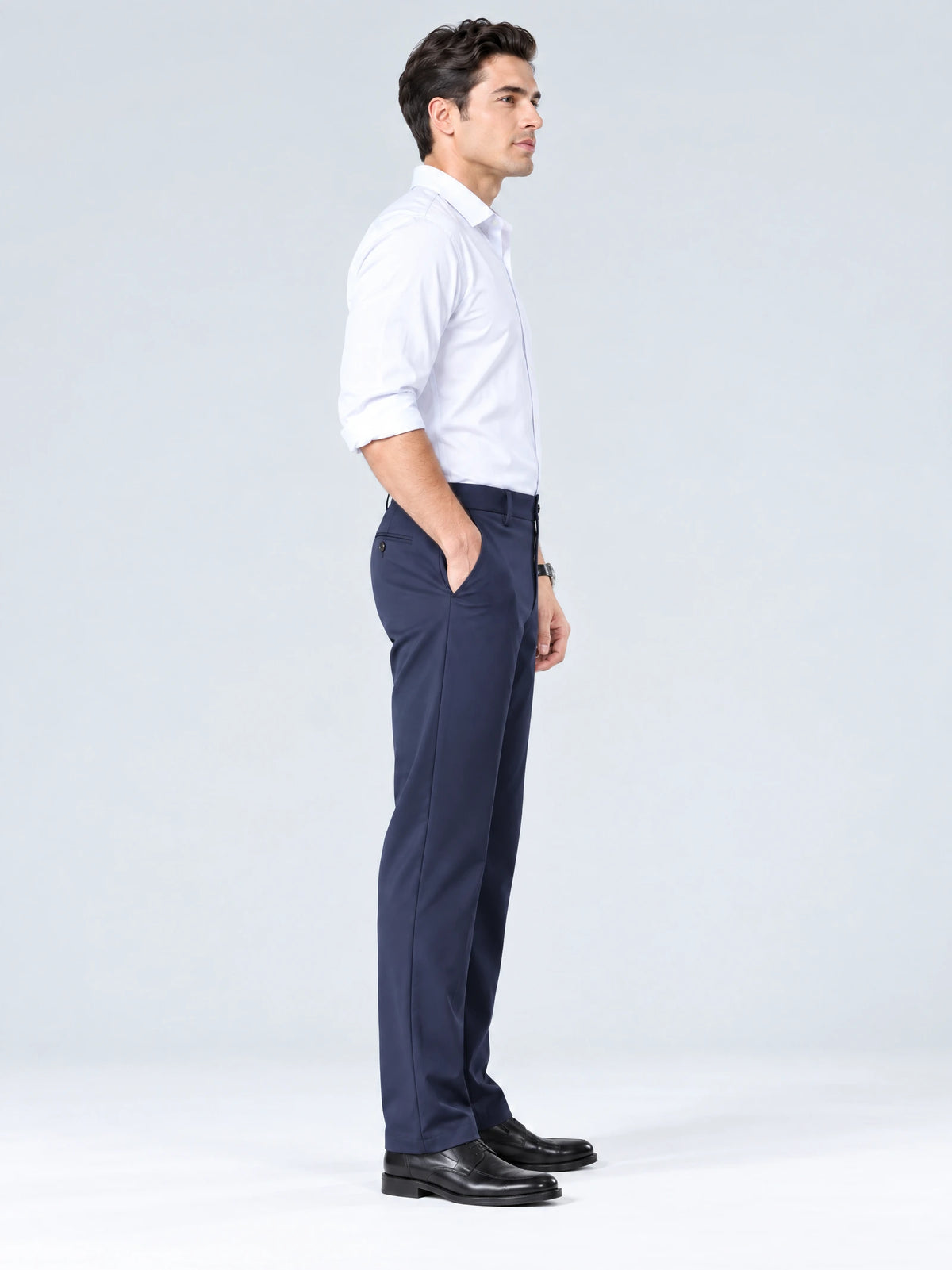 Side studio view of a model wearing Navy men's straight pants with a hand in the side pocket.
