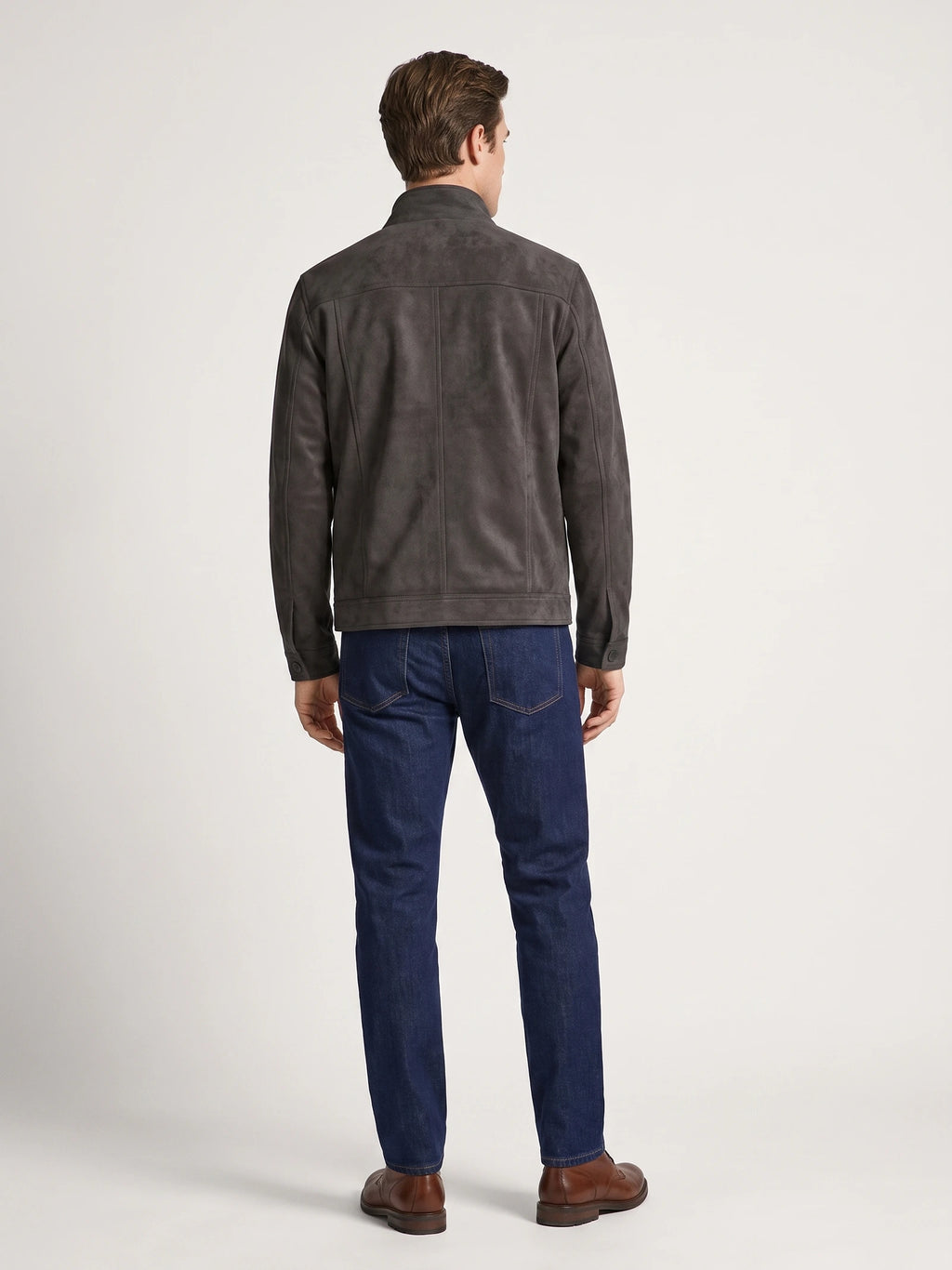 Rear studio view of a model wearing a Gray faux suede fall jacket with a stand collar, paneled back seams, and buttoned cuffs.