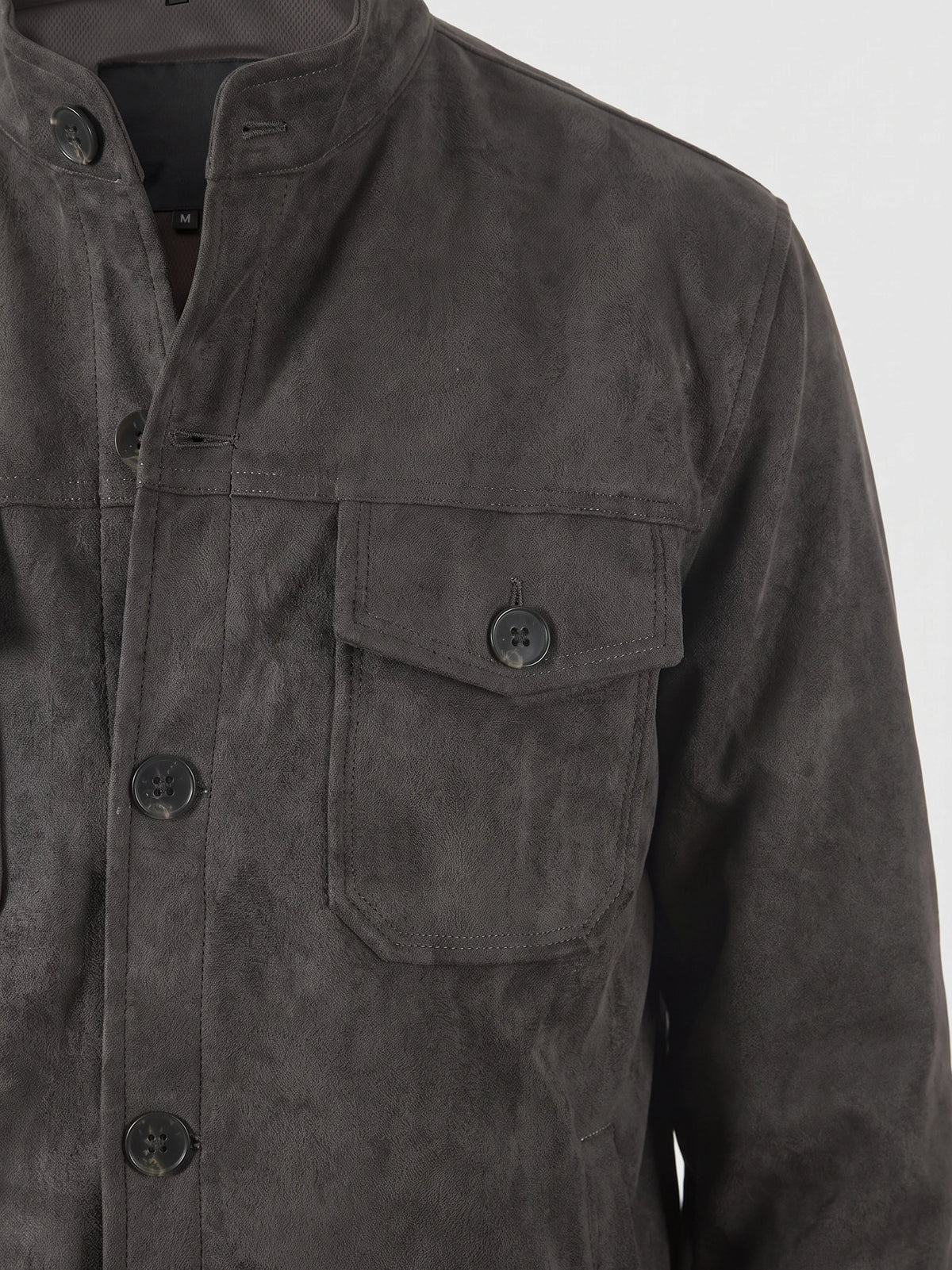 Gray faux suede fall jacket detail showing the stand collar, button front, and buttoned chest flap pocket.