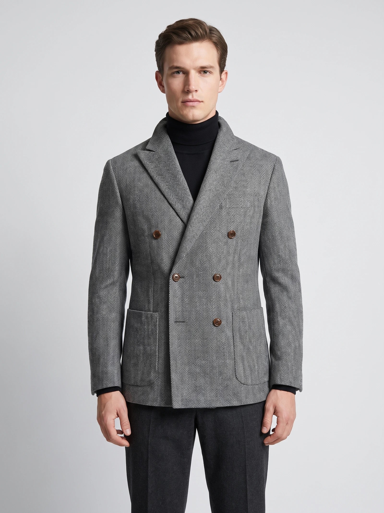 Front studio view of a model wearing a Gray Men Suit Coat with herringbone wool texture, peaked lapels, flap pockets, and double-breasted buttons.