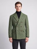 Front studio view of a model wearing a Green Men Suit Coat with herringbone texture, double-breasted buttons, and flap pockets.