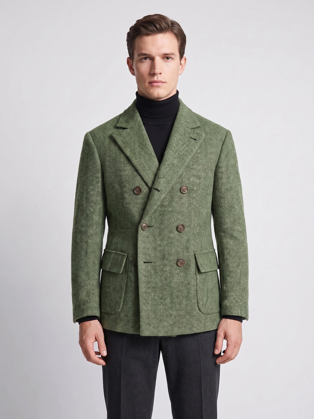 Front studio view of a model wearing a Green Men Suit Coat with herringbone texture, double-breasted buttons, and flap pockets.
