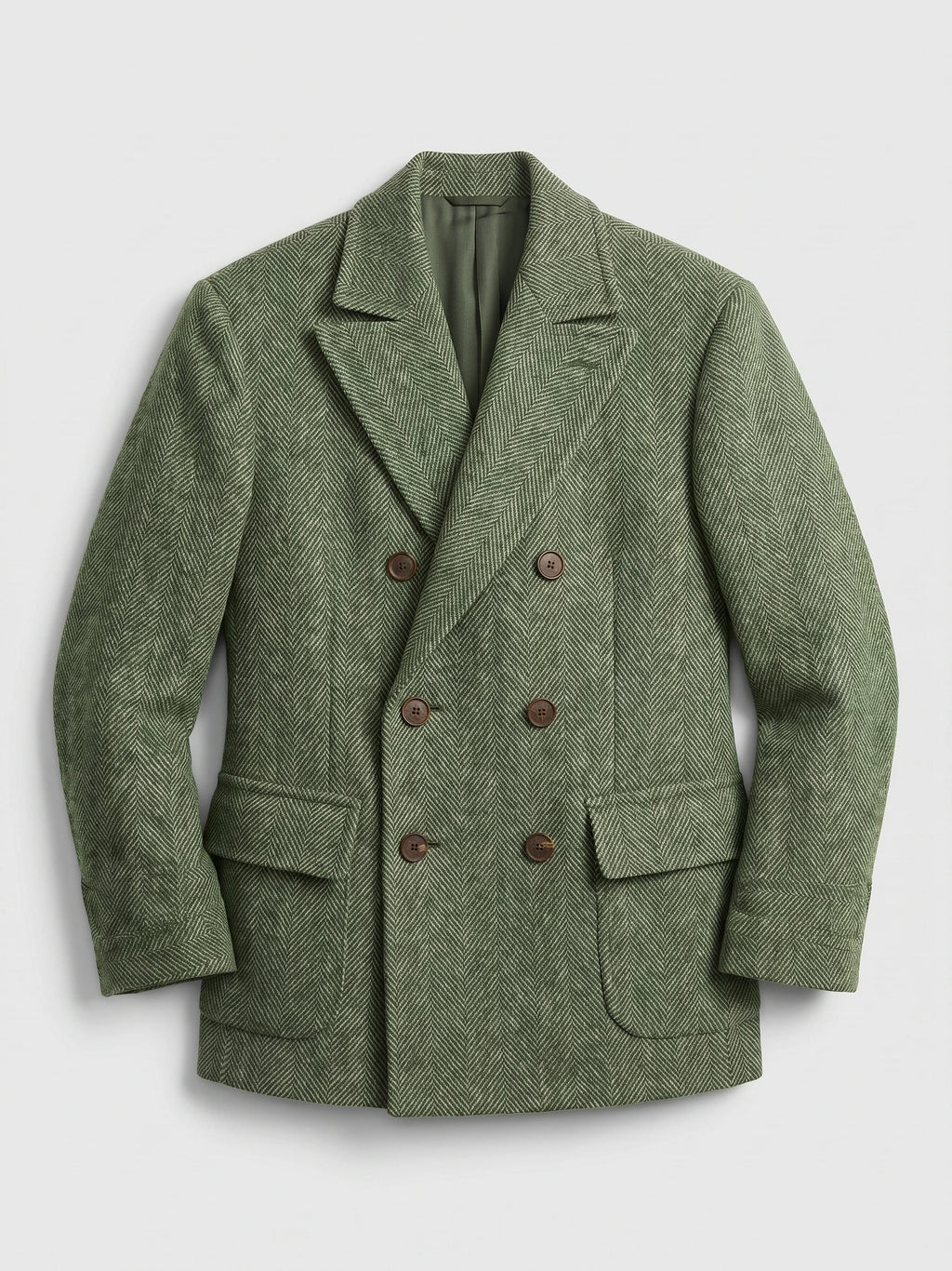 Green Men Suit Coat laid flat, featuring a herringbone weave, peaked lapels, flap pockets, and double-breasted buttons.