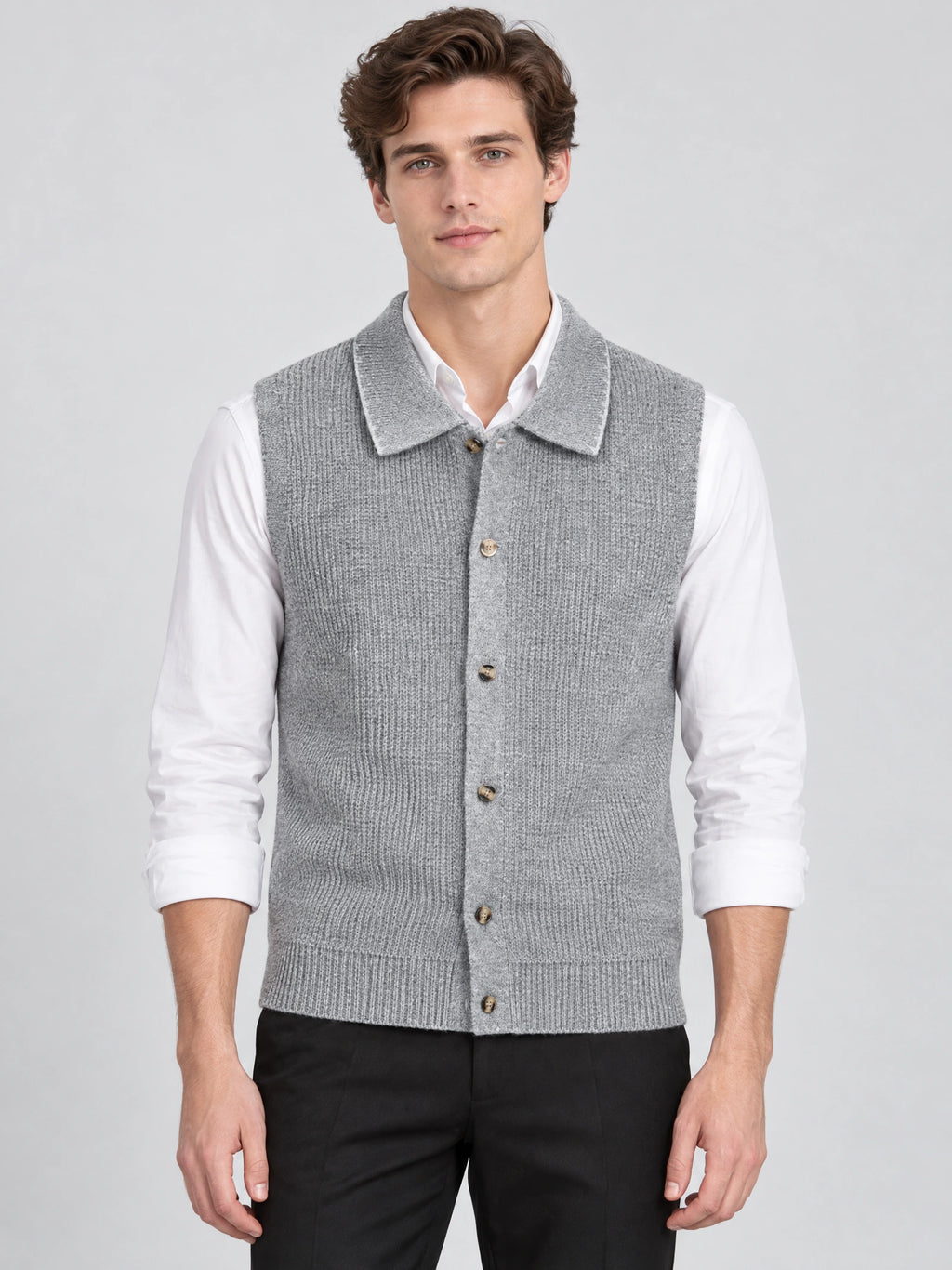 Front studio view of a model wearing a Gray cotton knit Sweater Vest with a lapel collar and single-breasted button closure.