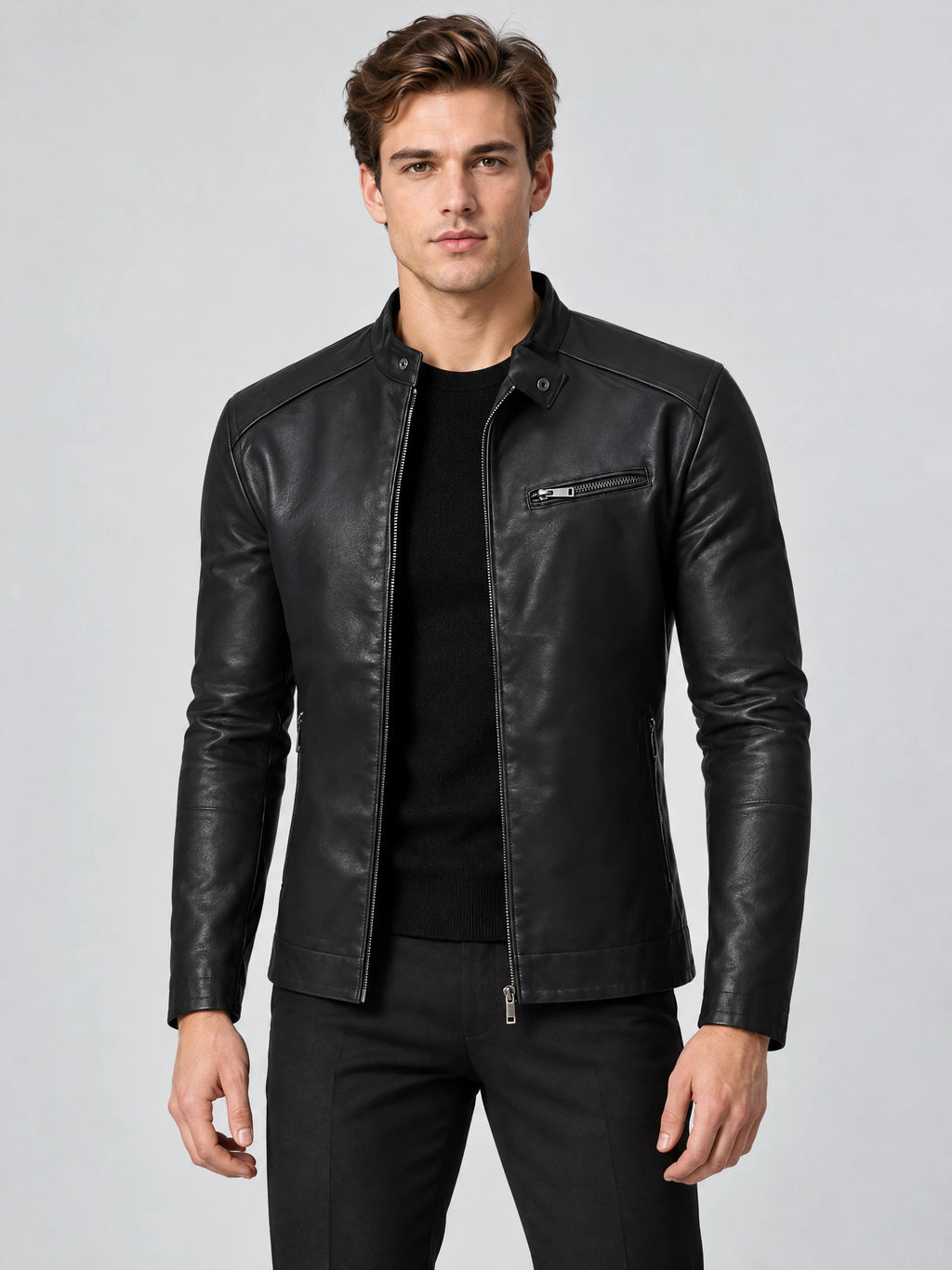 Front studio view of a model wearing a Black tailored leather jacket with a stand collar, zip front, and chest zip pocket.
