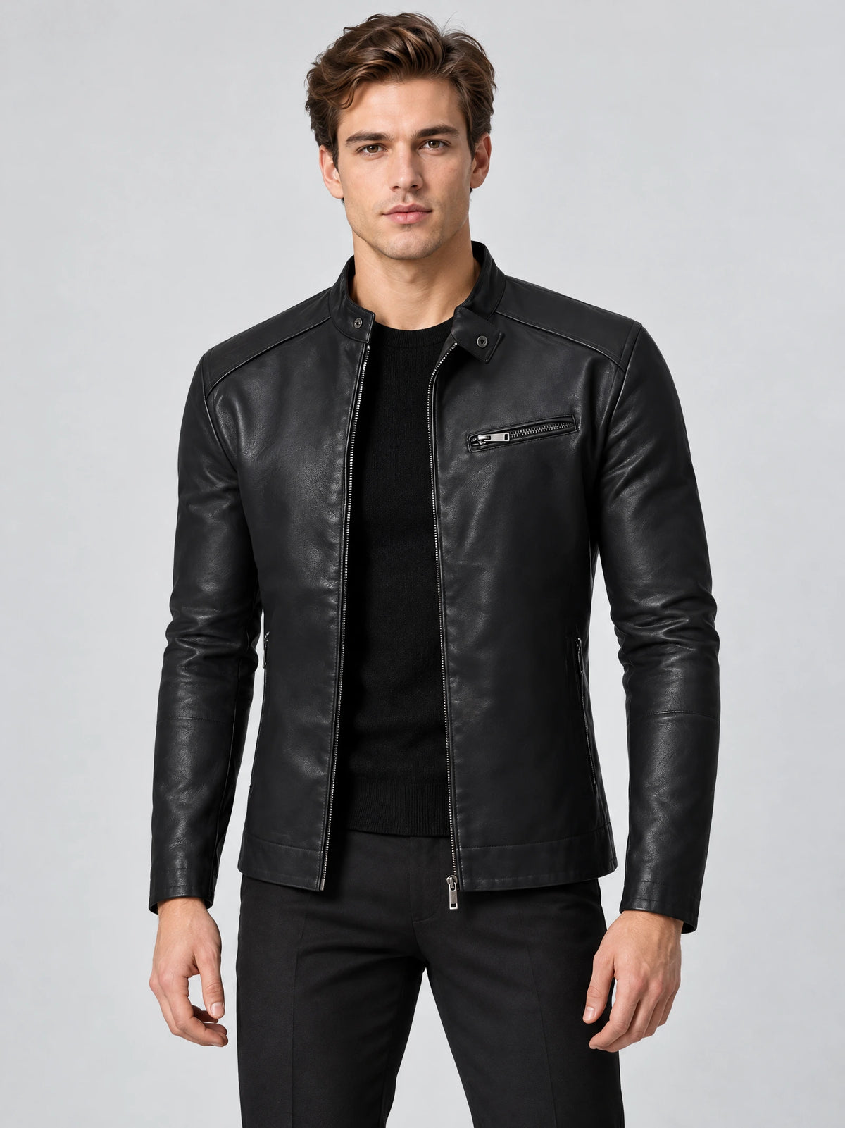 Front studio view of a model wearing a Black tailored leather jacket with a stand collar, zip front, and chest zip pocket.