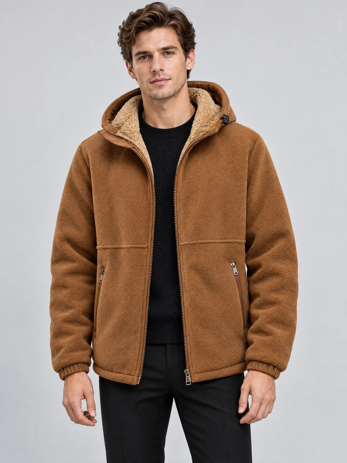 Front studio view of a model wearing a Brown teddy jacket with a hood, zip front, and zippered pockets.
