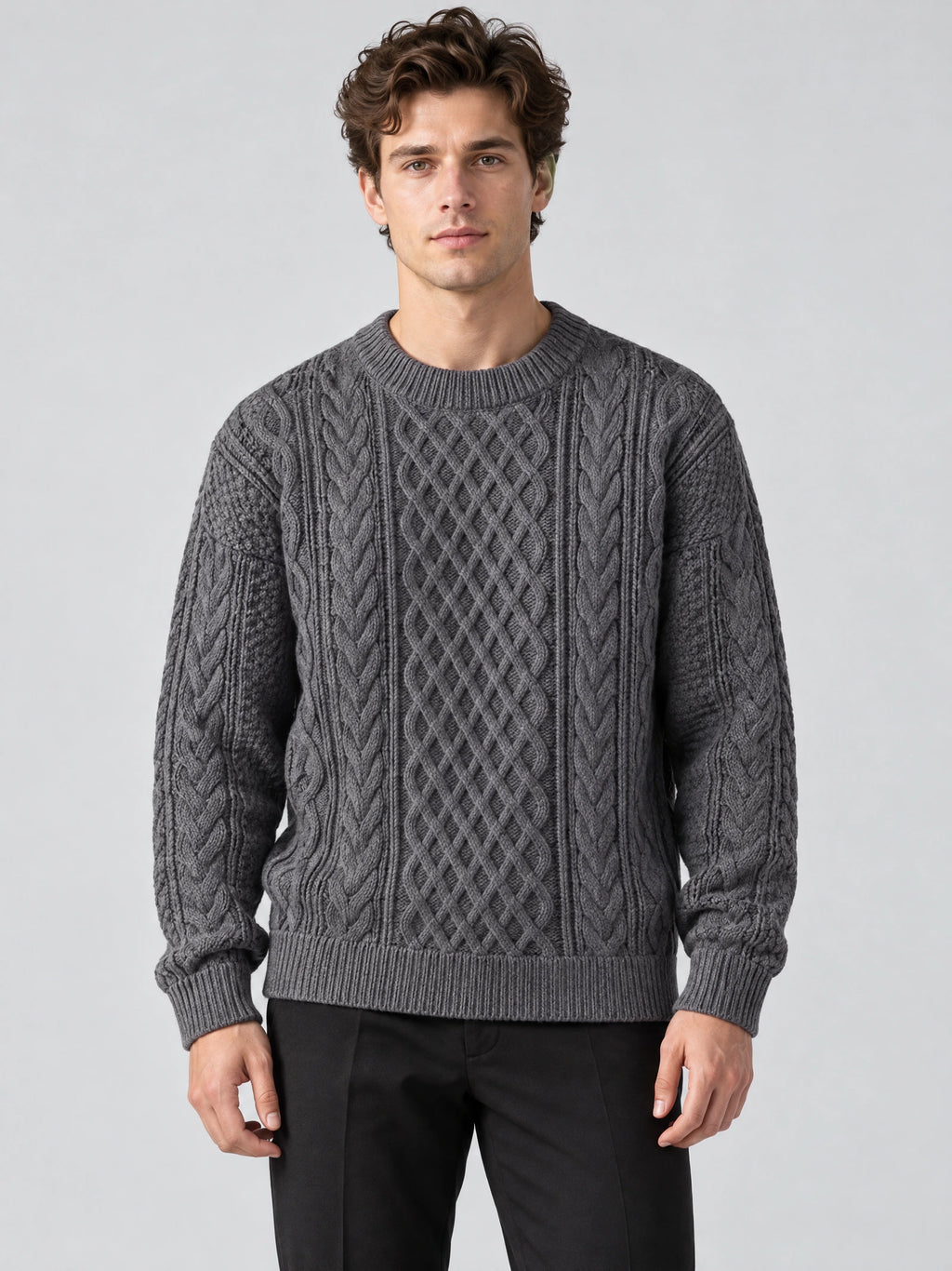 Front studio view of a model wearing a Charcoal Thick Sweater with an O-neck and textured cable-knit pattern.