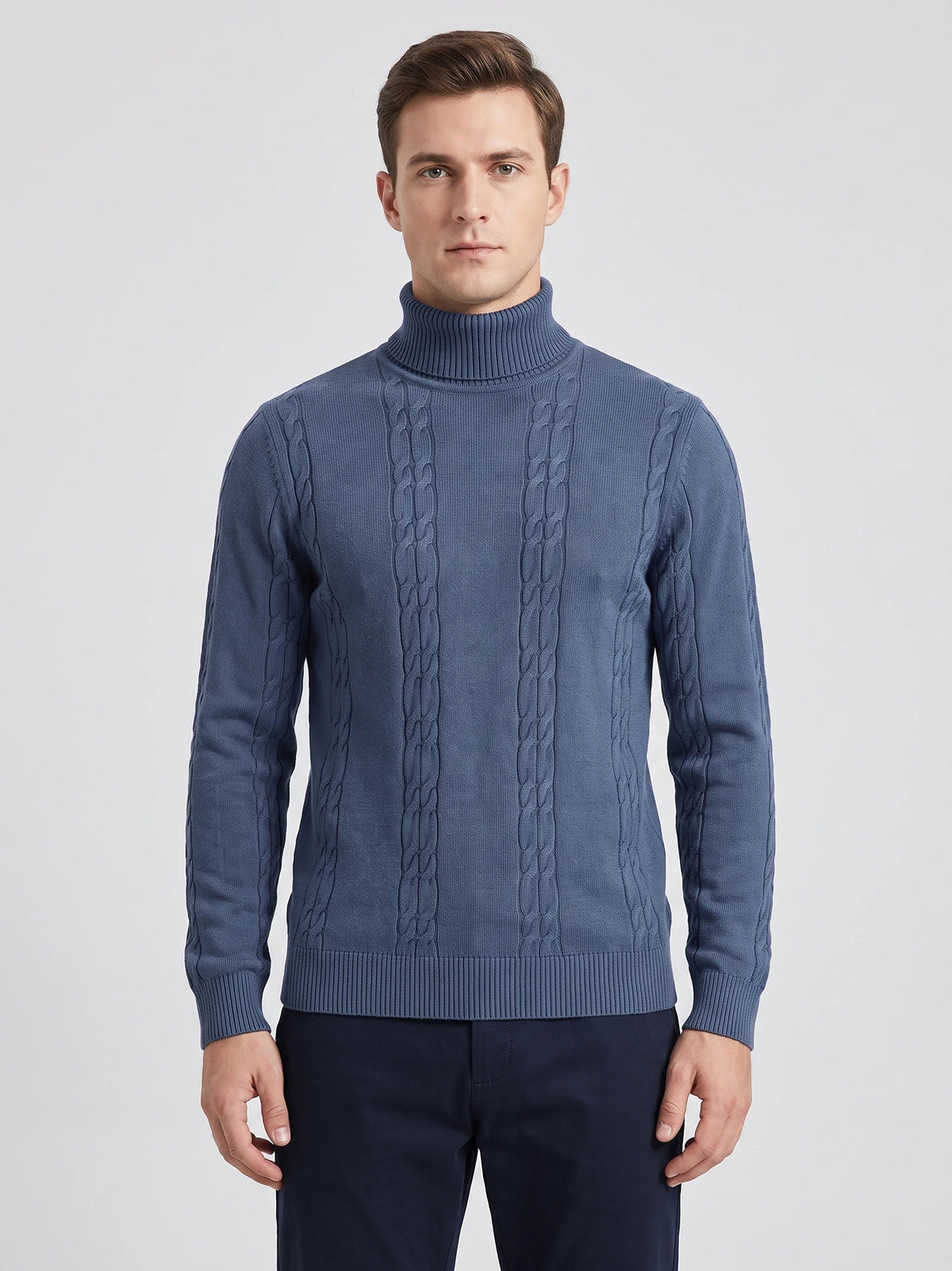 Front studio view of a model wearing a Blue cotton turtleneck sweater with vertical cable-knit detailing.
