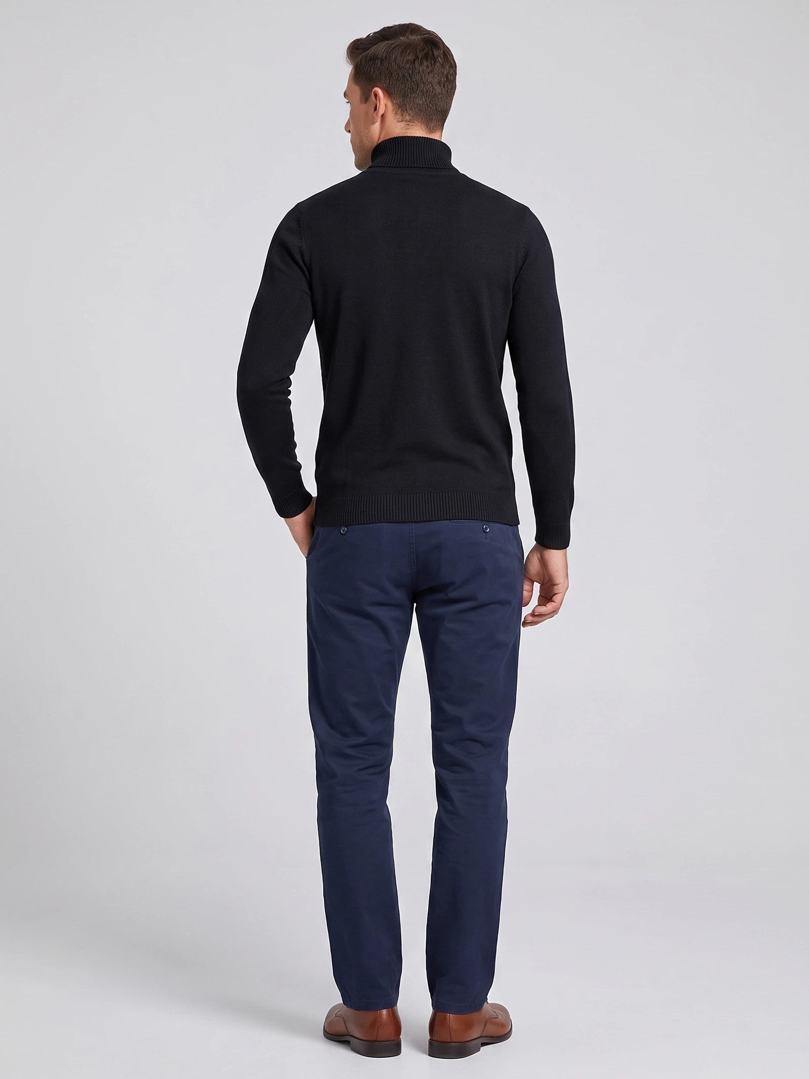Rear studio view of a model wearing a Black Turtleneck Sweater with a ribbed high neck, cuffs, and hem.