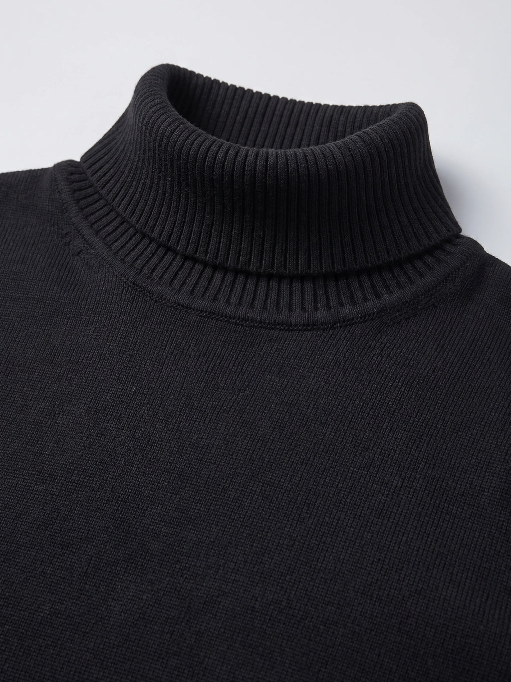 Close-up of the ribbed high neck and knit texture on a Black men's Turtleneck Sweater.