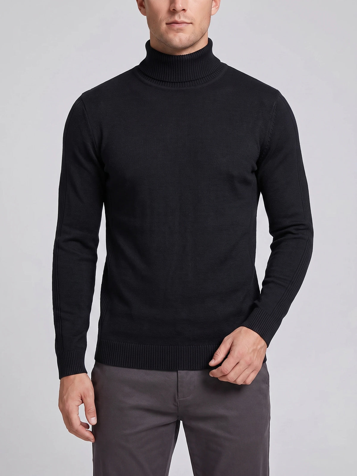 Front studio view of a model wearing a Black slim-fit Turtleneck Sweater with long sleeves and ribbed collar, cuffs, and hem.