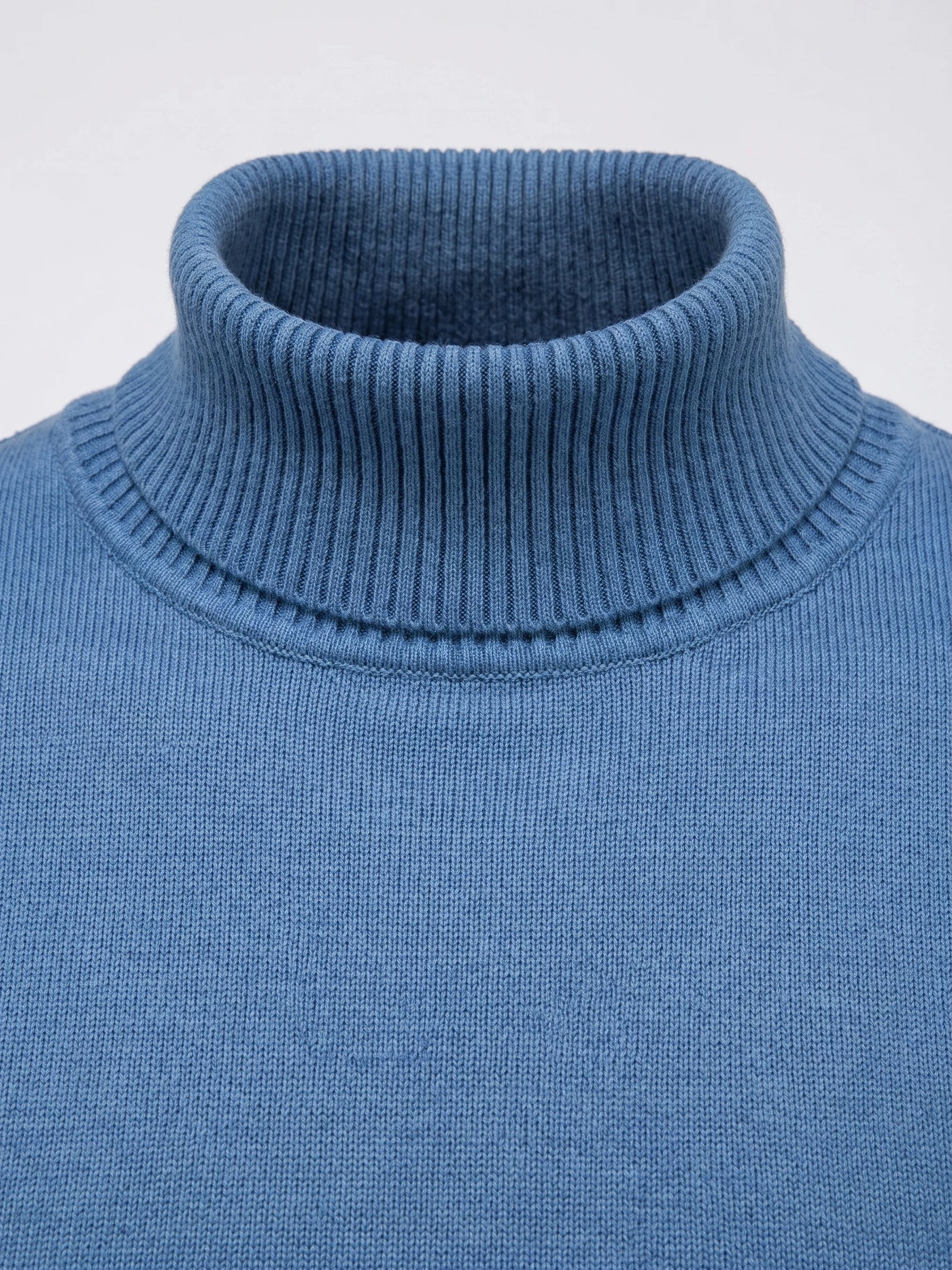 Close-up of the ribbed high neck and fine knit texture on a Blue men's Turtleneck Sweater.