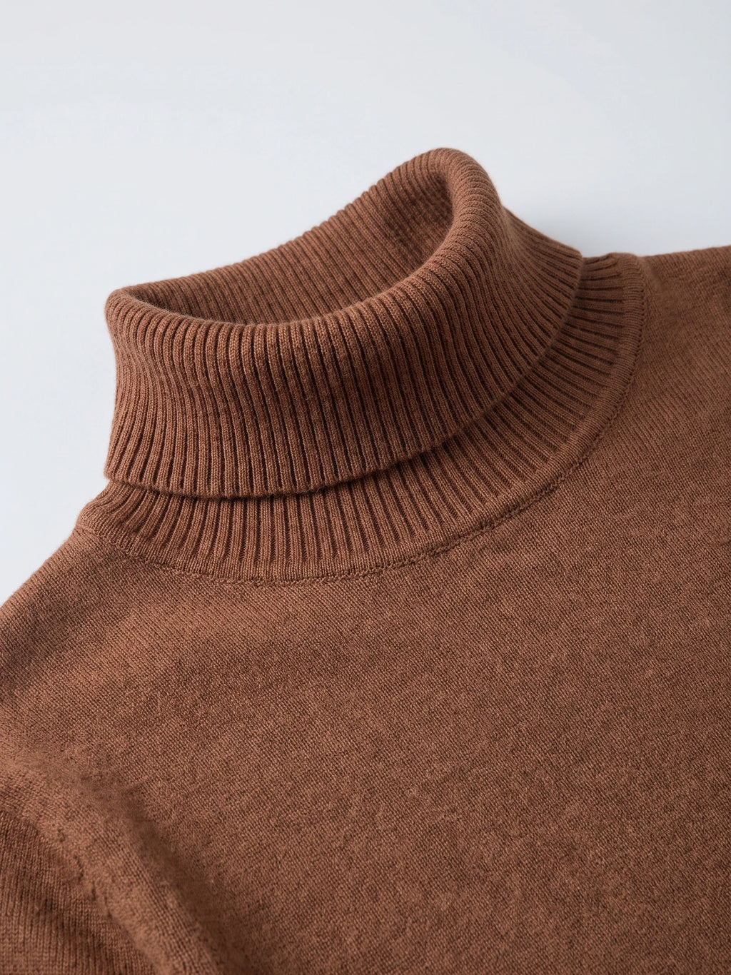 Close-up of the Brown Turtleneck Sweater showing its ribbed fold-over high neck and fine knit texture.