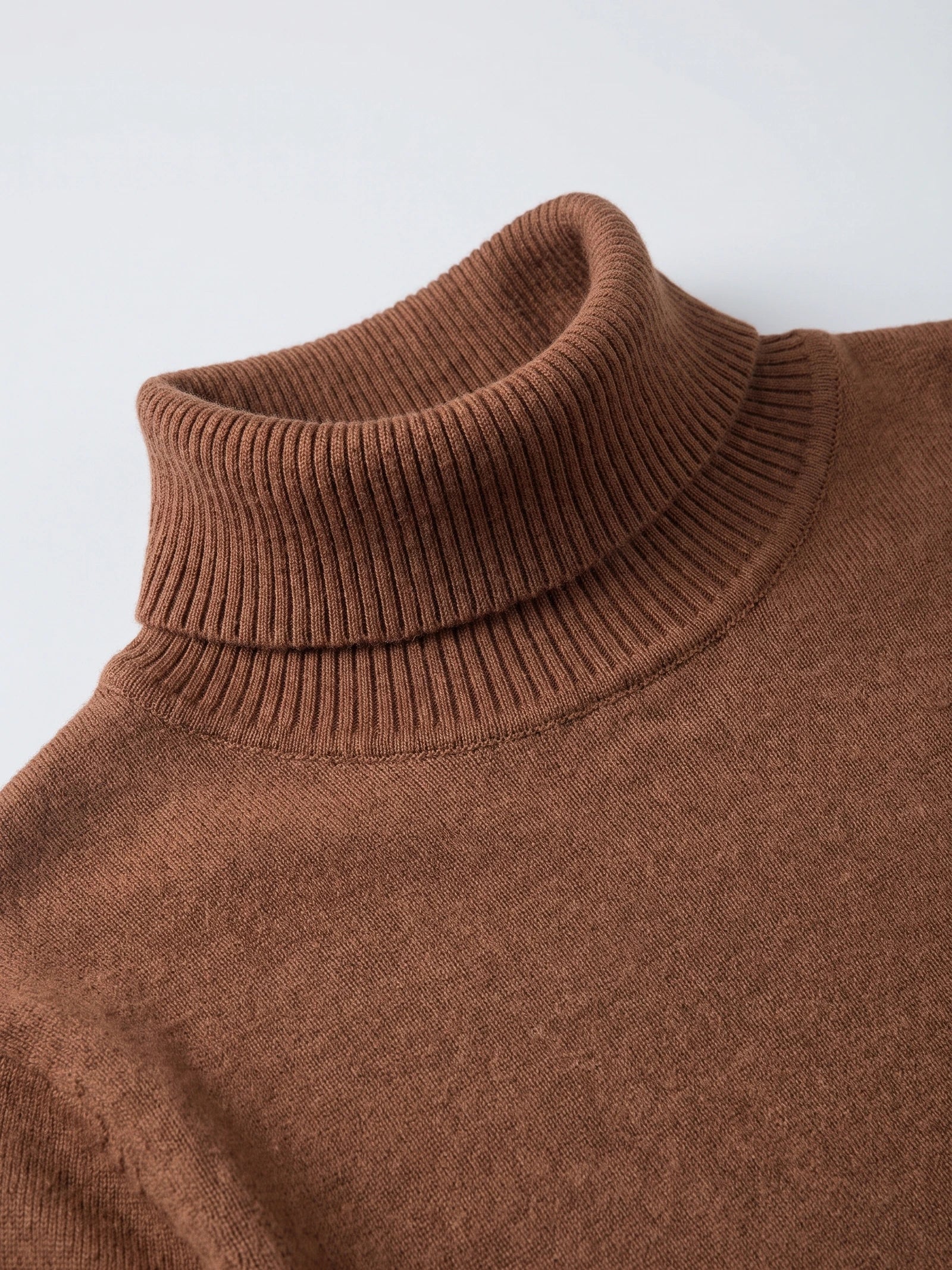 Close-up of the Brown Turtleneck Sweater showing its ribbed fold-over high neck and fine knit texture.