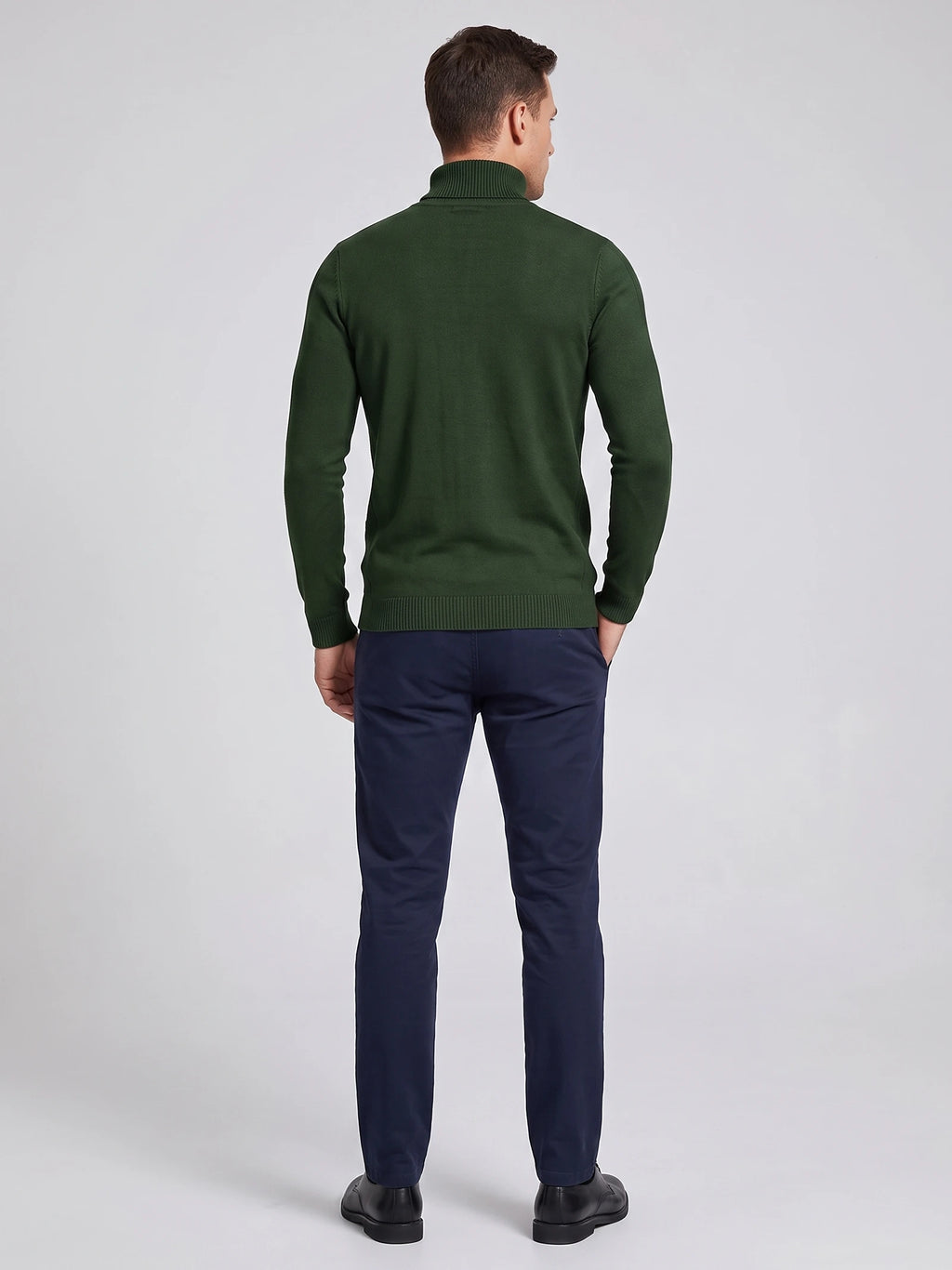 Rear studio view of a model wearing a Green men's Turtleneck Sweater with long sleeves and ribbed collar, cuffs, and hem.