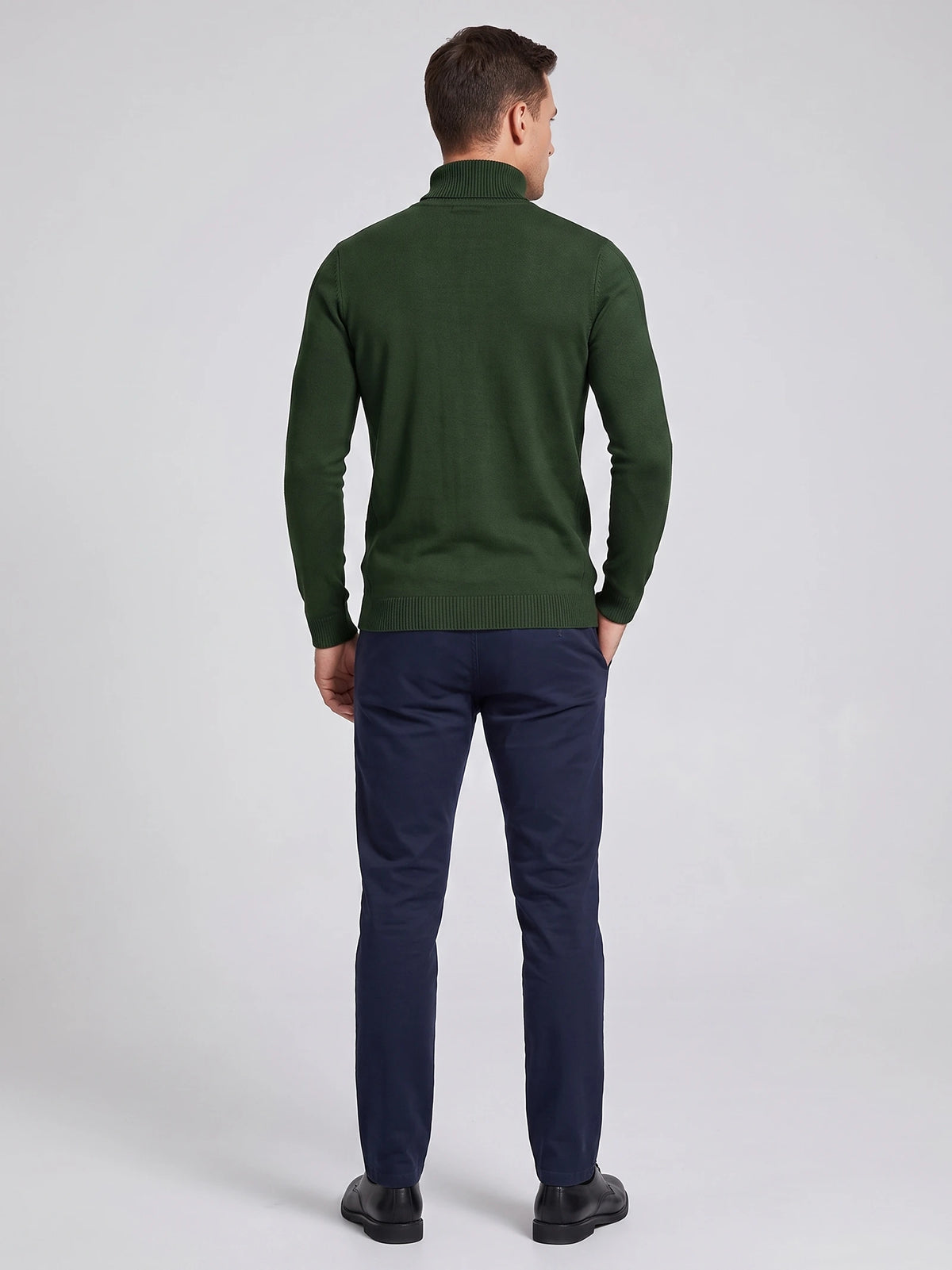 Rear studio view of a model wearing a Green men's Turtleneck Sweater with long sleeves and ribbed collar, cuffs, and hem.