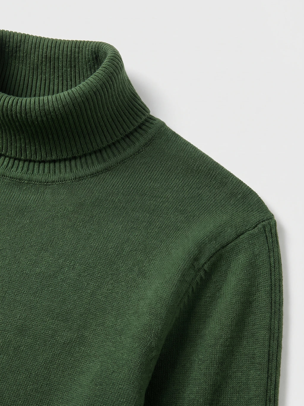 Close-up of the Green men’s Turtleneck Sweater showing its ribbed high neck, knit texture, and shoulder seam.