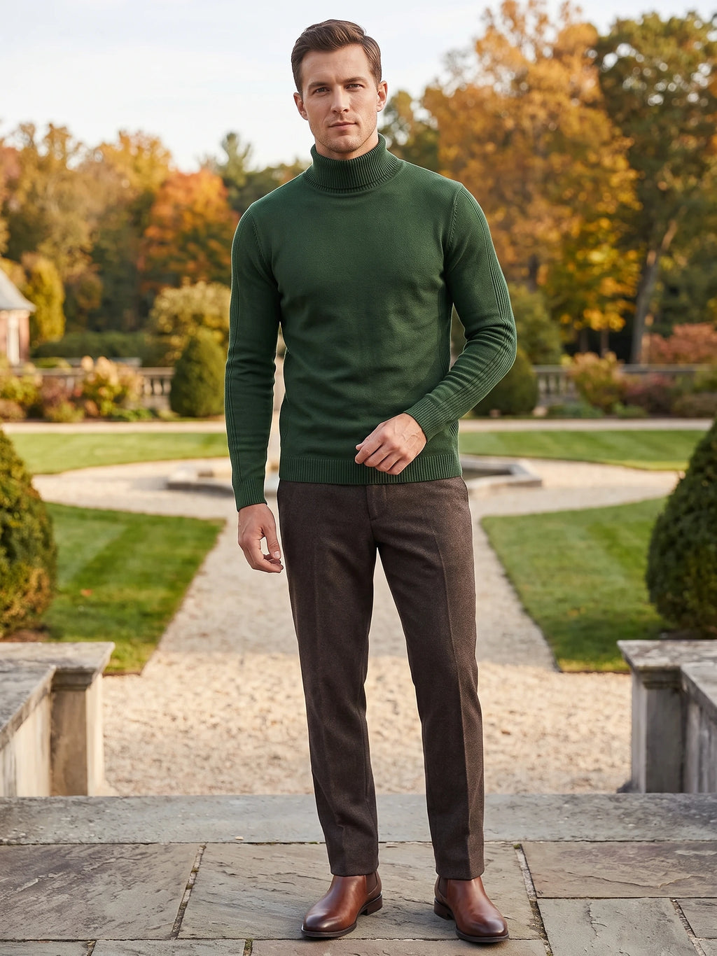 Model wearing a Green turtleneck sweater with ribbed collar, cuffs, and hem while standing on a garden path.