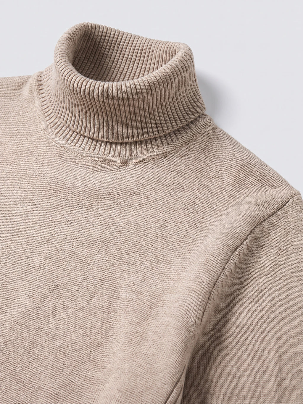 Close-up of the ribbed high neck and knit texture on a Khaki men's turtleneck sweater.