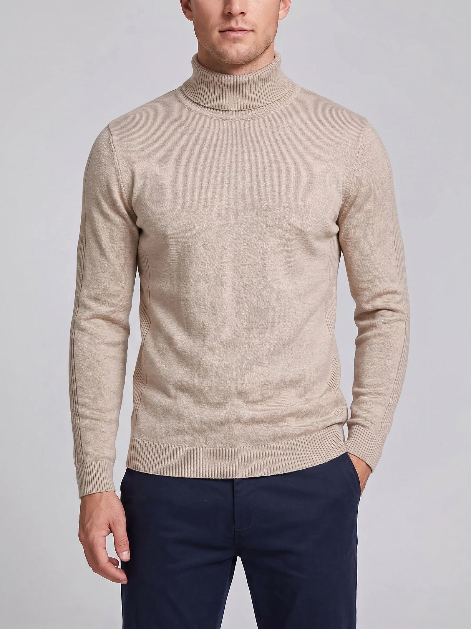 Front studio view of a model wearing a Khaki men's Turtleneck Sweater with a ribbed high neck, cuffs, and hem.