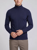 Front studio view of a model wearing a Navy Turtleneck Sweater with a ribbed high neck, cuffs, and hem.