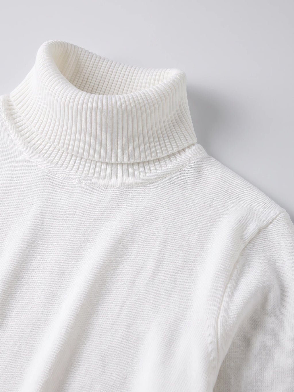 Close-up of the ribbed high neck and fine knit texture on a White men's Turtleneck Sweater.