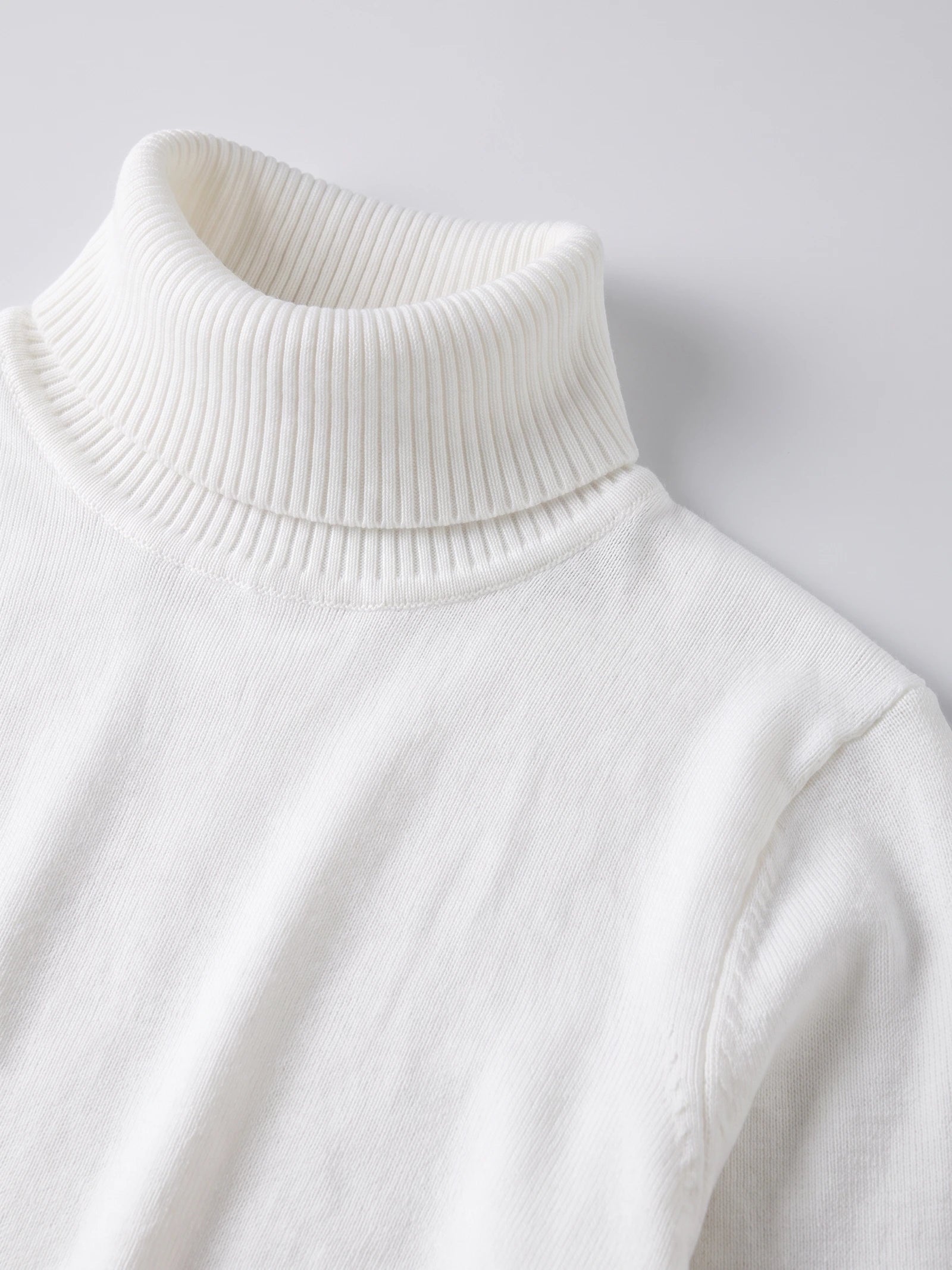Close-up of the ribbed high neck and fine knit texture on a White men's Turtleneck Sweater.