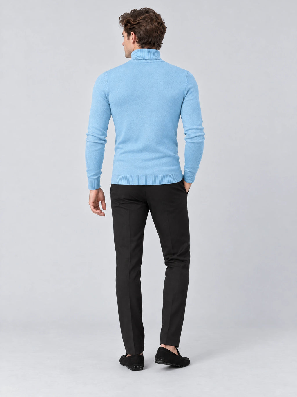 Rear studio view of a model wearing a Light Blue men's Turtleneck Sweater with long sleeves and ribbed cuffs and hem.