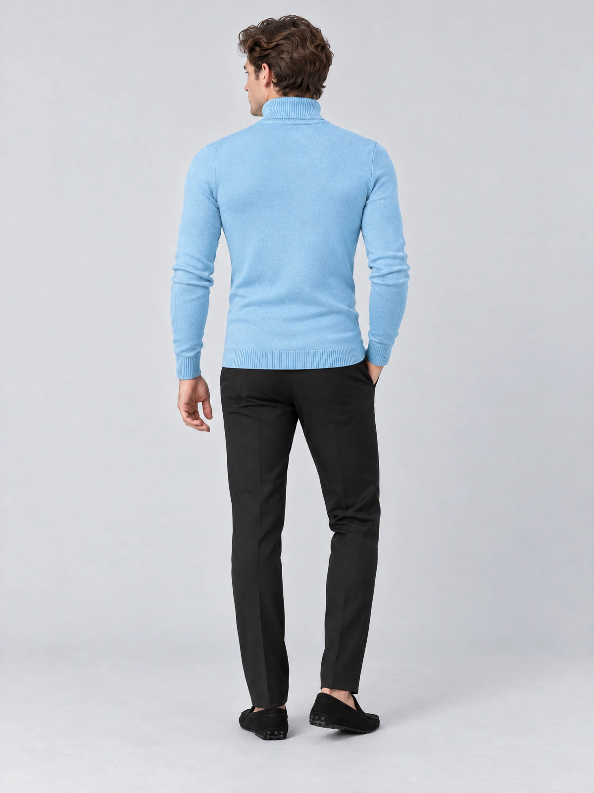 Rear studio view of a model wearing a Light Blue men's Turtleneck Sweater with long sleeves and ribbed cuffs and hem.
