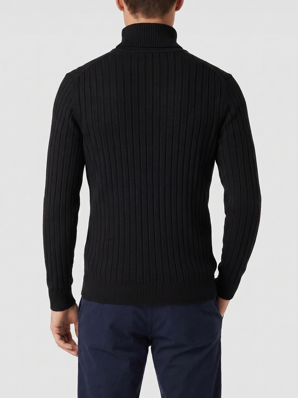 Rear view of a model wearing a Black ribbed knit Turtleneck Sweater with long sleeves and a high collar.