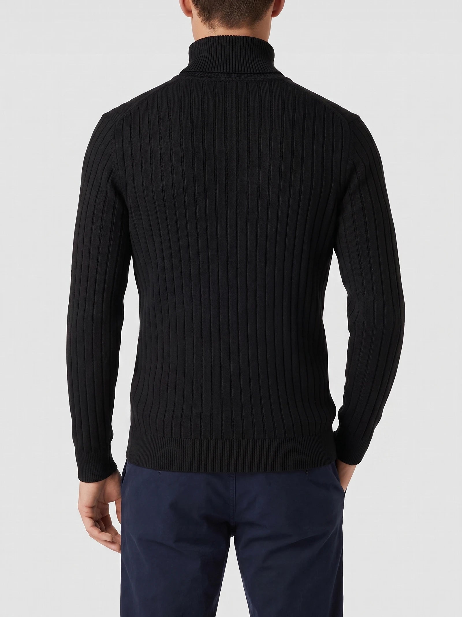 Rear view of a model wearing a Black ribbed knit Turtleneck Sweater with long sleeves and a high collar.