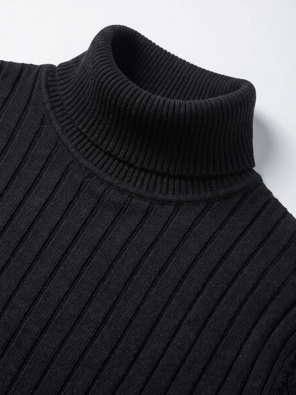 Close-up of the Black men’s Turtleneck Sweater, showing its ribbed fold-over collar and vertical knit texture.