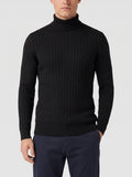 Front studio view of a model wearing a Black Turtleneck Sweater with vertical ribbed knit texture.