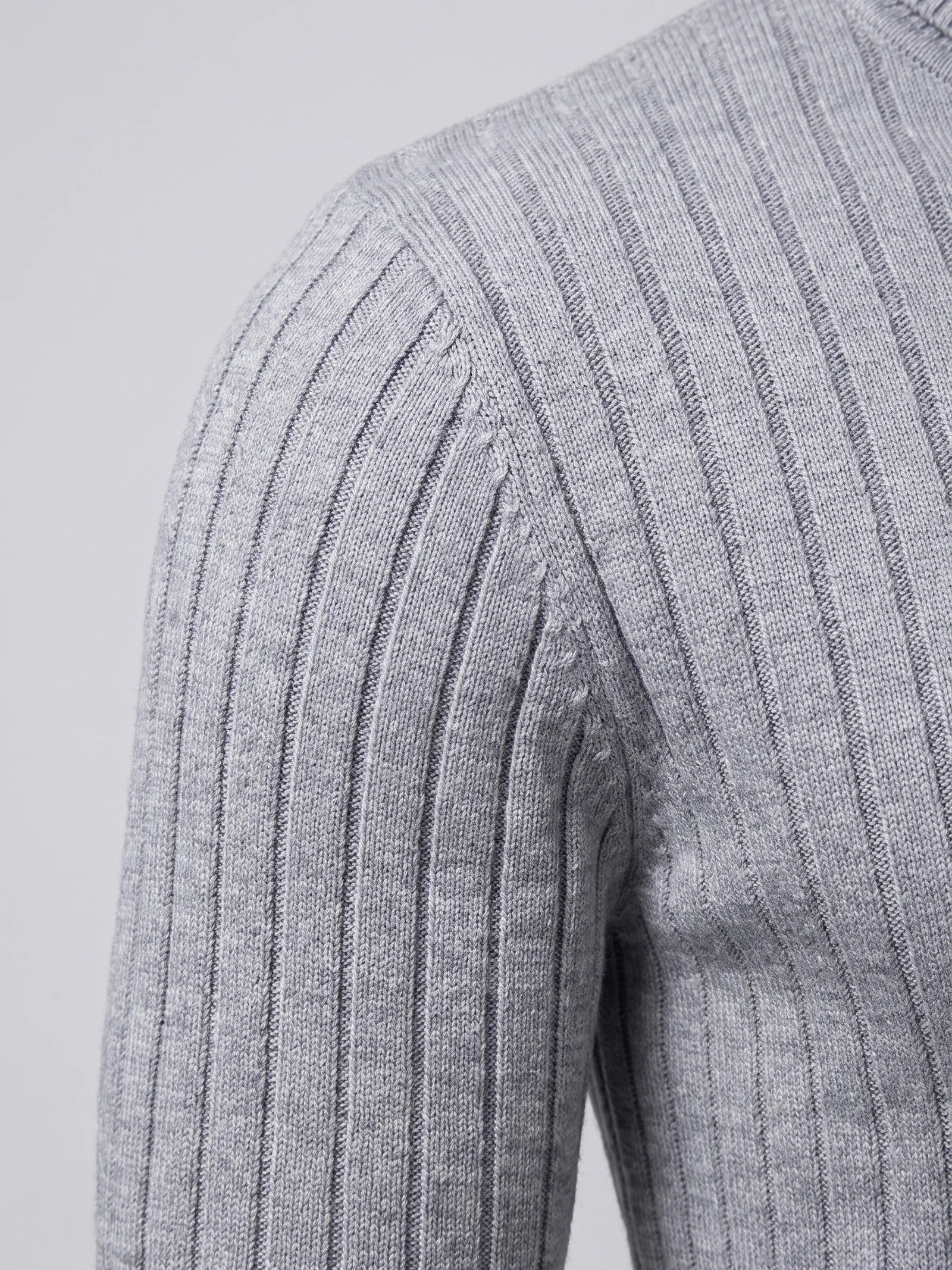 Close-up of the Gray men's turtleneck sweater showing its vertical ribbed knit texture at the shoulder and sleeve.