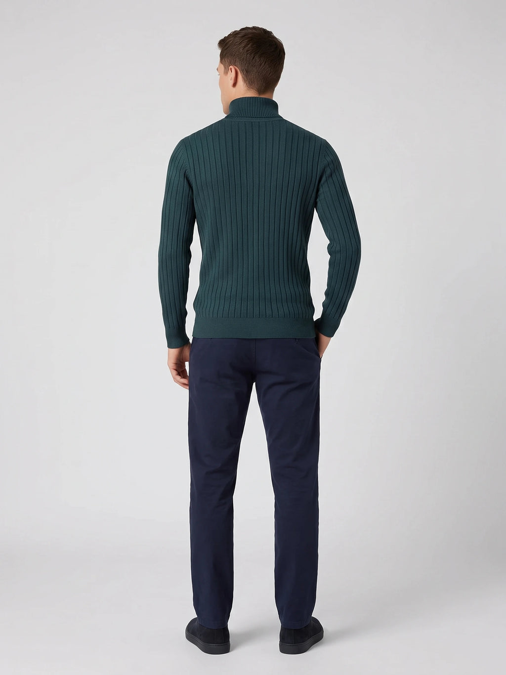 Rear studio view of a model wearing a Green ribbed Turtleneck Sweater with long sleeves and a high collar.
