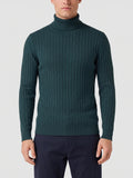 Front studio view of a model wearing a Green ribbed Turtleneck Sweater with a high collar and long sleeves.