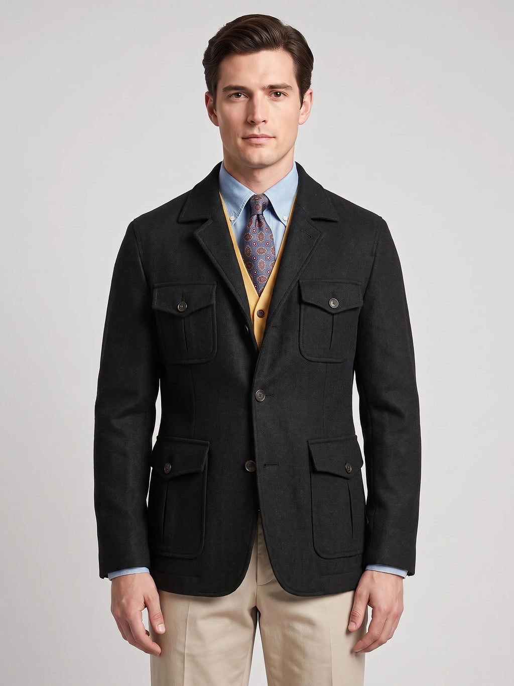 Front studio view of a model wearing a Black Tweed Jacket with a notched lapel, button closure, and four flap pockets.