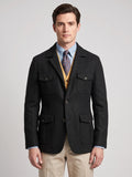 Front studio view of a model wearing a Black Tweed Jacket with a notched lapel, button closure, and four flap pockets.