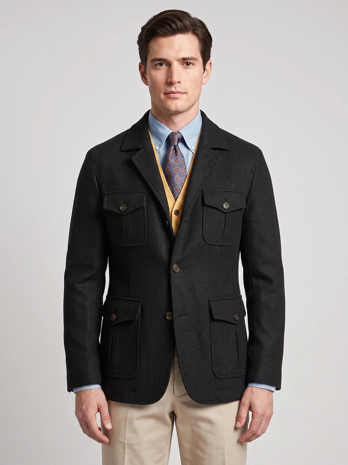 Front studio view of a model wearing a Black Tweed Jacket with a notched lapel, button closure, and four flap pockets.