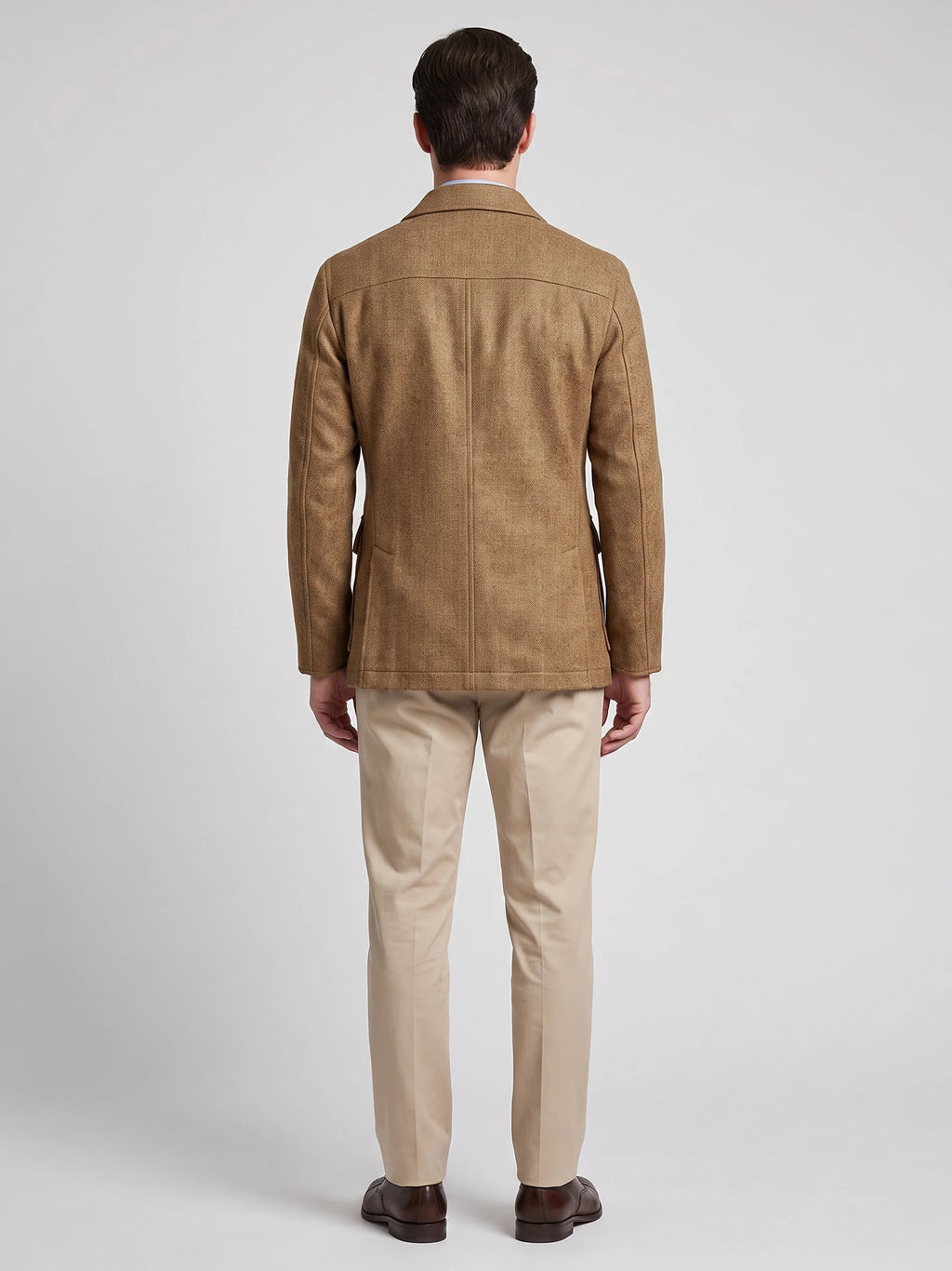 Rear studio view of a model wearing a Khaki men's Tweed Jacket, showing the tailored back seam and slim fit.