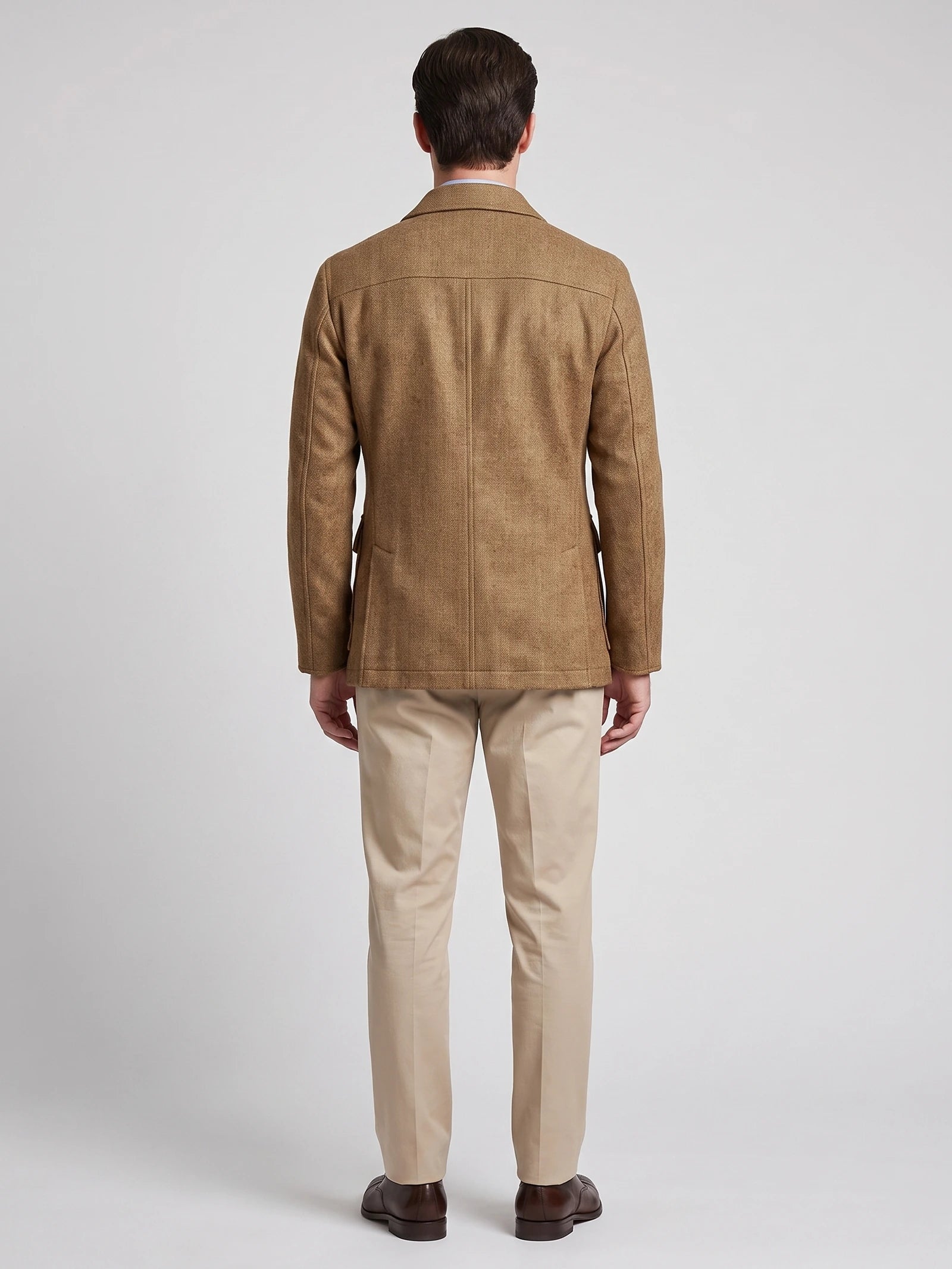 Rear studio view of a model wearing a Khaki men's Tweed Jacket, showing the tailored back seam and slim fit.