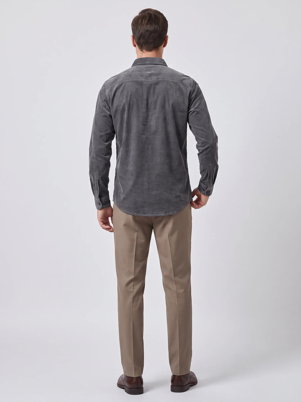 Rear studio view of a model wearing a Gray Twill Tweed Shirt, showing the back yoke, long sleeves, and curved hem.
