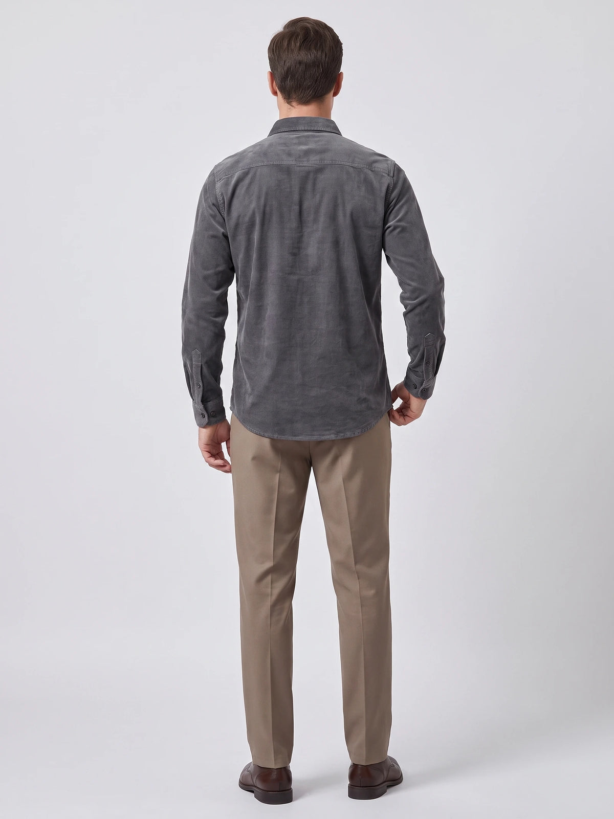 Rear studio view of a model wearing a Gray Twill Tweed Shirt, showing the back yoke, long sleeves, and curved hem.