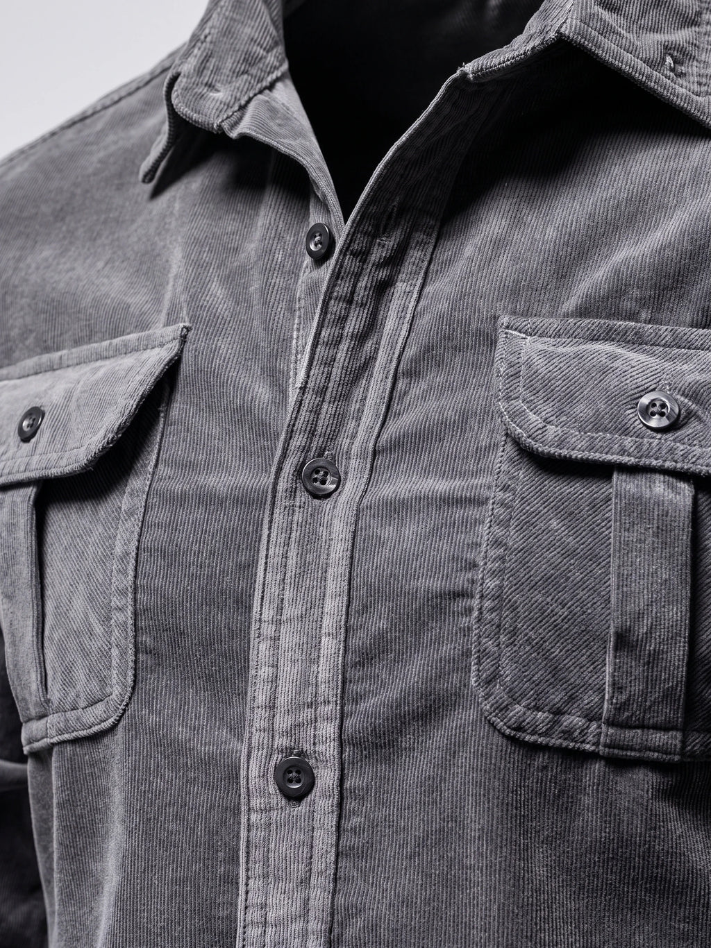 Close-up of the Gray Twill Tweed Shirt showing its fine ribbed texture, pointed collar, button placket, and flap chest pockets.