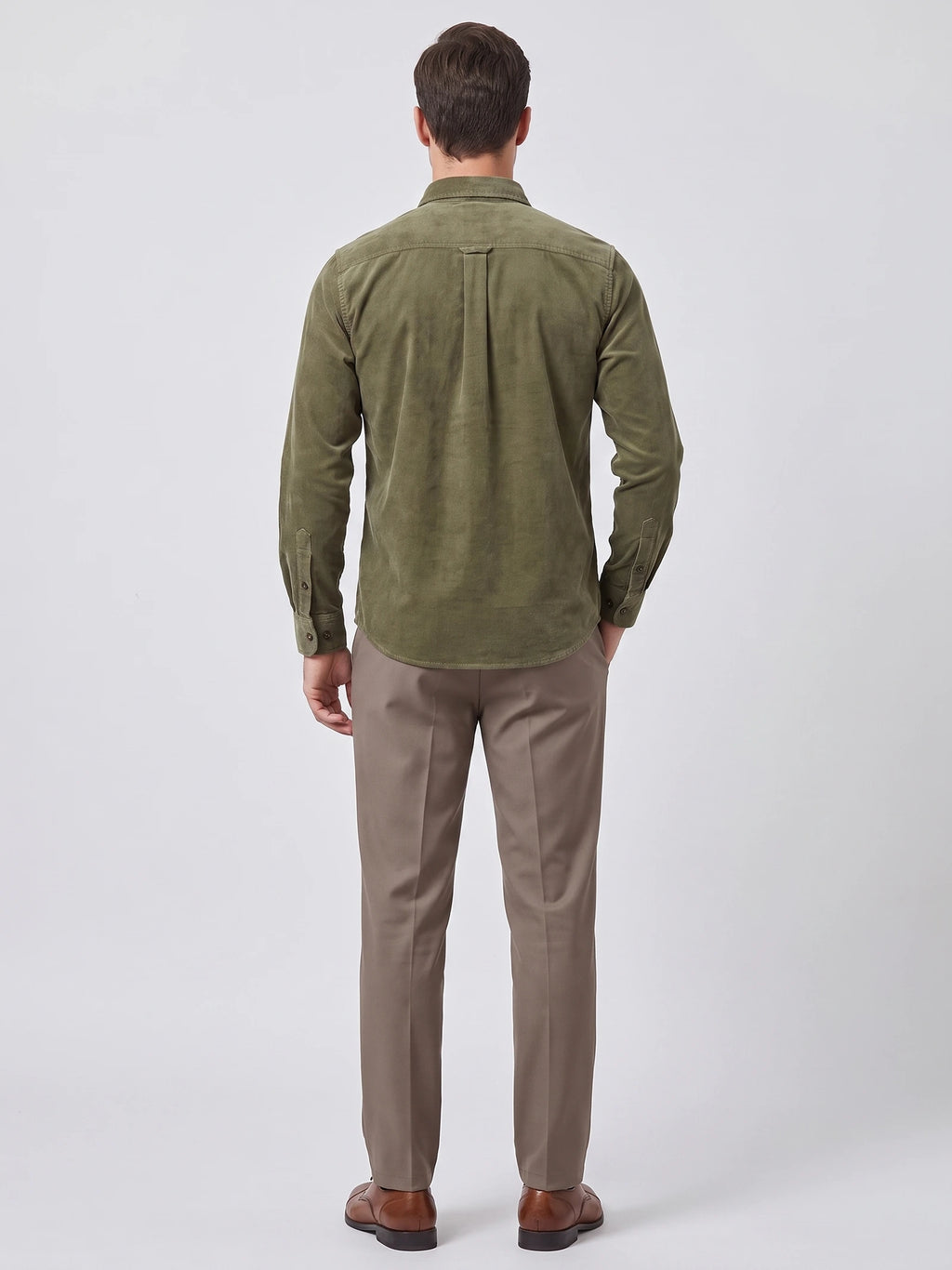 Rear studio view of a model wearing a Green Twill Tweed Shirt, showing the back yoke, center pleat, and button cuffs.